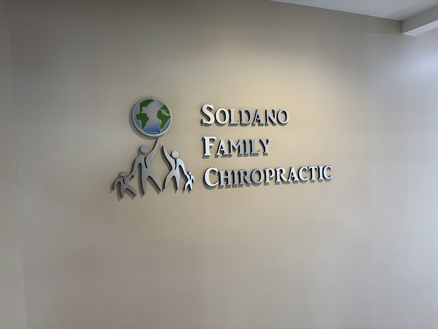 Soldano Family Chiropractic Center logo on the lobby wall