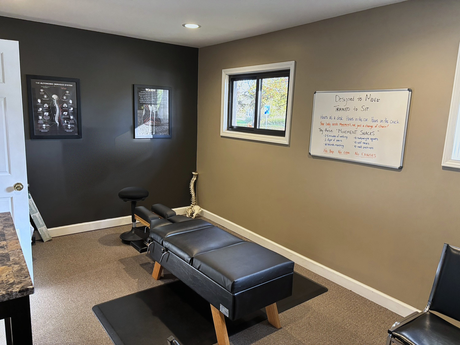 Adjustment room with a Designed to Move whiteboard at the Kalamazoo clinic